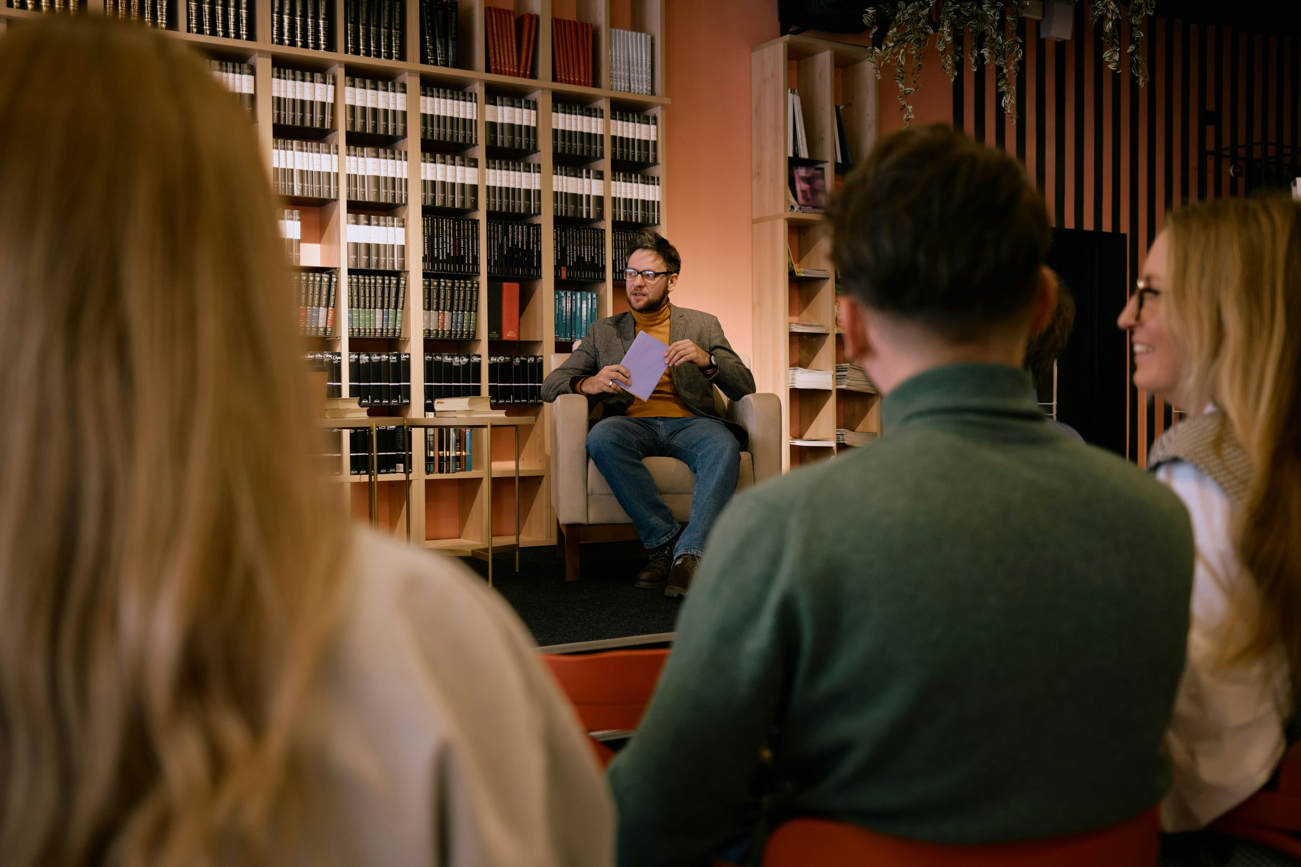 Author speaking to an audience at a literary event